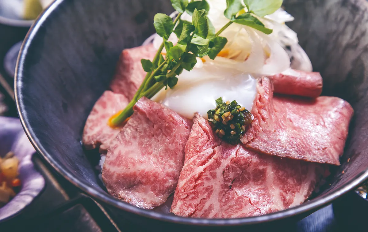 Thinly sliced beef and soft-boiled egg rice bowl