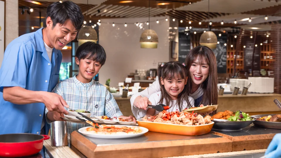 A family getting food from a buffet