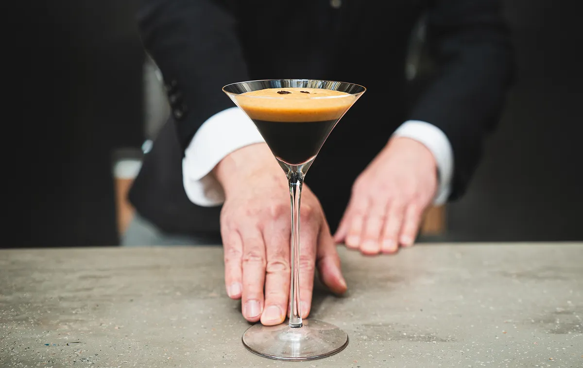 A bartender at Ocean45 LOUNGE & BAR serving an espresso martini.