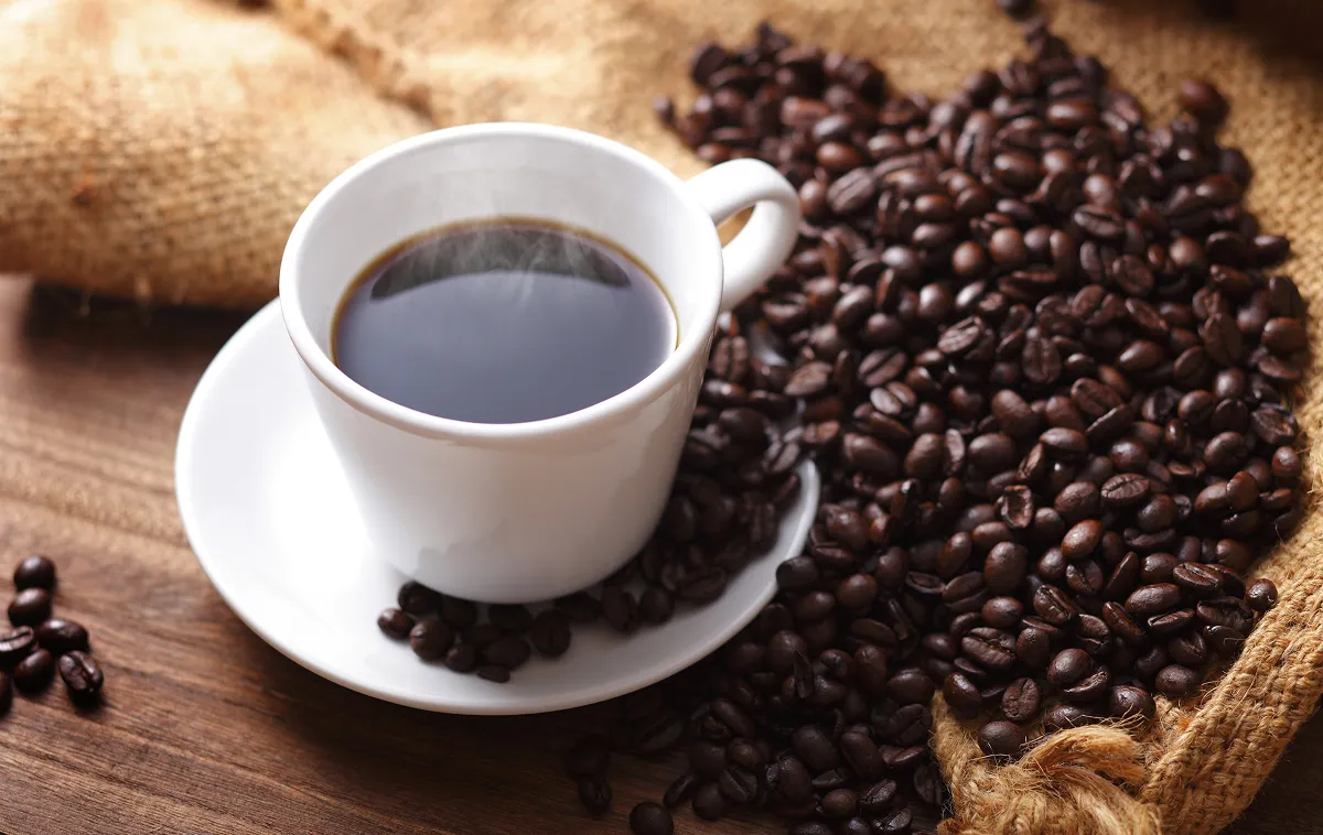 Freshly brewed coffee and roasted coffee beans