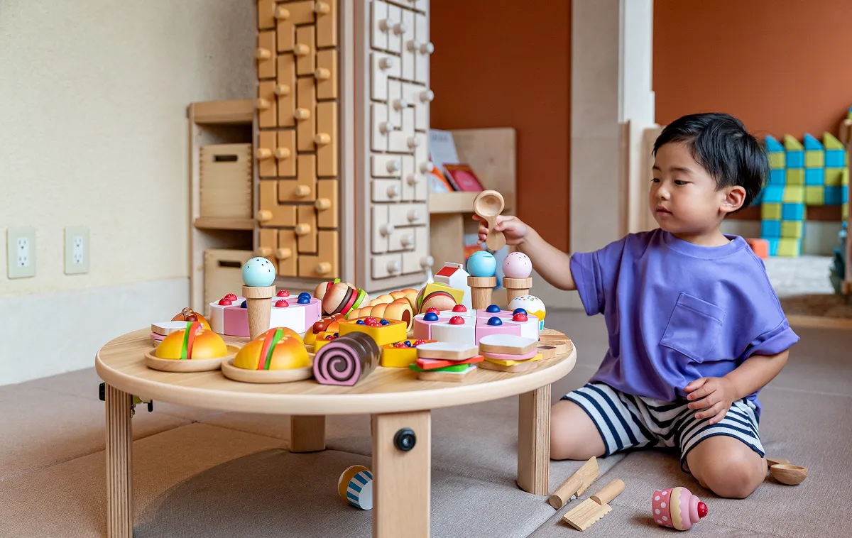 Toddlers playing with wooden toys at KIDS OASIS