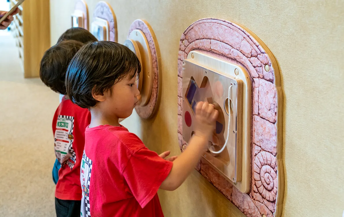 Children playing with wall panels at KIDS OASIS